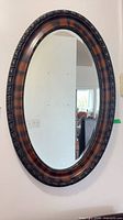 Full view of oval wall mirror on wall