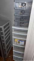 Two tall plastic drawer units and small 4-drawer stacker