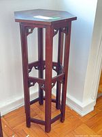 Full view of hexagonal wood plant stand showing legs and stretchers