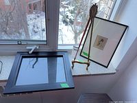 Overall lot showing brass stand, framed print, empty black frame