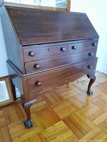 Full view of closed secretary desk showing fallboard, drawers, legs
