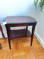 Full view of wooden side table showing shelf and legs