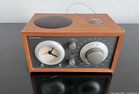 Front view of Tivoli Audio Model Three radio showing controls and clock