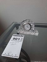 Front view of Waterford crystal clock on glass table