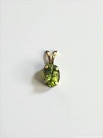 Front view of pendant showing peridot and bail