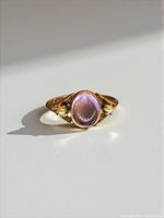 Front view of ring showing amethyst cabochon and seed pearls