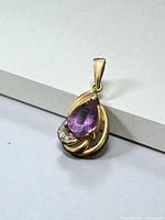 Front view of yellow gold pendant with amethyst and diamonds