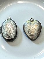 Front view of both pendants displaying engraved floral designs