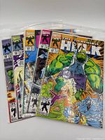 Group shot of five bagged Incredible Hulk comics