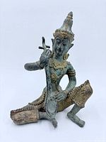 Front view of bronze kneeling musician statue