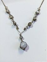Full view of sterling silver necklace with agate cabochons and drop pendant