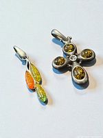 Front view of both sterling silver amber pendants