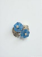 Top view showing two blue glass flowers and leaf details of sterling silver ring