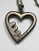 Front of open heart Coach pendant on chain