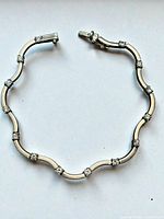 Full view of curved link sterling bracelet closed