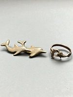 Brooch and ring side by side showing overall design