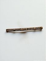 Top view of sterling silver filigree bar brooch