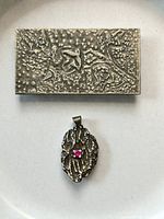 Front view of rectangular brooch and oval pendant