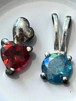 Front view of both pendants showing gemstones and mounts