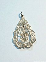 Front view showing filigree frame and goddess figure