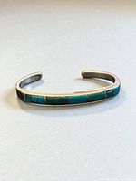 Front view showing turquoise inlay on silver cuff