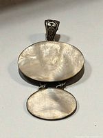 Front view of pendant showing both mother of pearl cabochons and bail