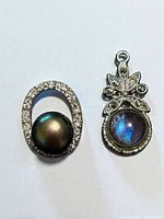 Front view of both pendants showing stones and cabochons