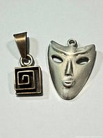 Front view of both sterling silver pendants