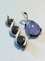 Front view of both sterling silver purple gemstone pieces