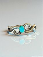 Front view showing full scroll design and turquoise stone