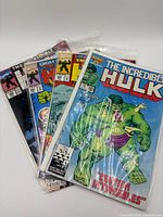 Stack of four bagged Incredible Hulk comics, partial covers visible