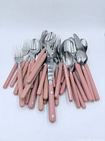 Entire pile of pink-handled stainless flatware