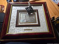 Framed sterling silver relief with tag attached