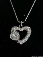 Close-up of Swarovski double heart pendant on chain