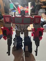 Front view of Optimus Prime figure holding two rifles