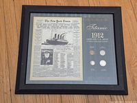Full view of framed newspaper reproduction and coin set