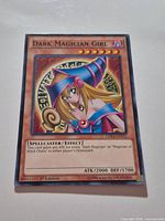 Front of Dark Magician Girl card showing artwork, text box and set code