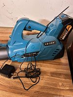 Leaf blower body with battery and charger visible