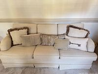 Front view of beige sofa with cushions