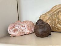 Pink sleeping rabbit and dark bird close-up