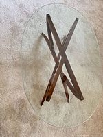 Full view of oval glass coffee table on carpet