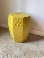 Front view of yellow glazed octagonal ceramic garden stool showing raised dot decoration