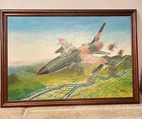 Full view of framed painting showing jet and landscape