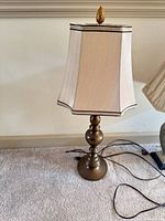 Turned column brass-tone lamp with square shade visible
