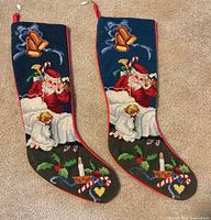Front view of both needlepoint stockings showing design details