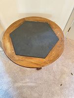 Top view showing round table with hexagonal black inset and paint spots
