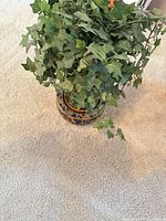 Top view of artificial ivy plant showing foliage and ceramic pot