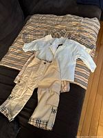 Overview of all clothing pieces laid on matching blanket