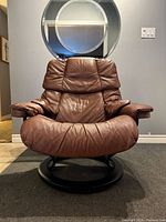Front view of brown leather swivel lounge chair