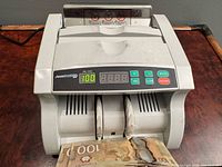 Front view of AccuBANKER AB-1000 money counter showing overall condition and design